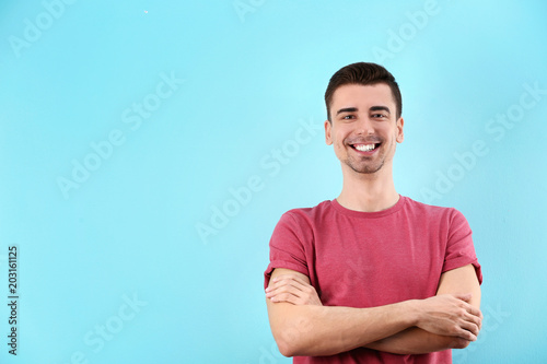 Charming young man on color background