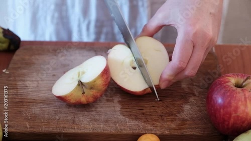 Cutting fruit on the kitchen table.
