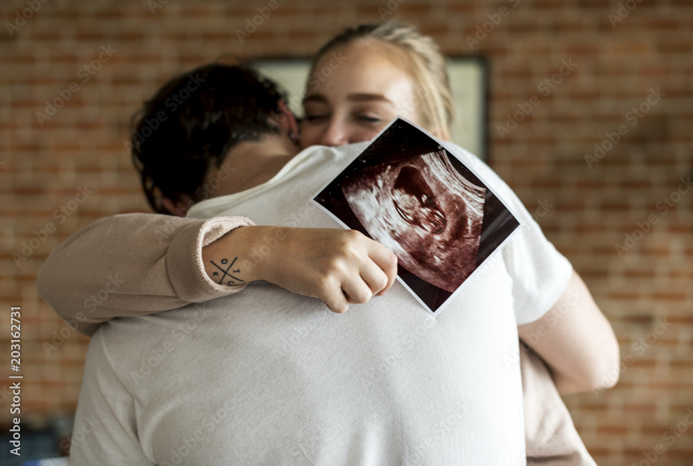 White couple with baby ultrasound photo - obrazy, fototapety, plakaty 