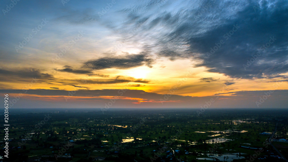 Panorama Top view Aerial photo from flying drone over village in Thailand.Top view beautiful Sunset.Sunrise with cloud over rice field. Panorama Top view Aerial photo from flying drone over village in Thailand.Top view beautiful Sunset.Sunrise with cloud over rice field.