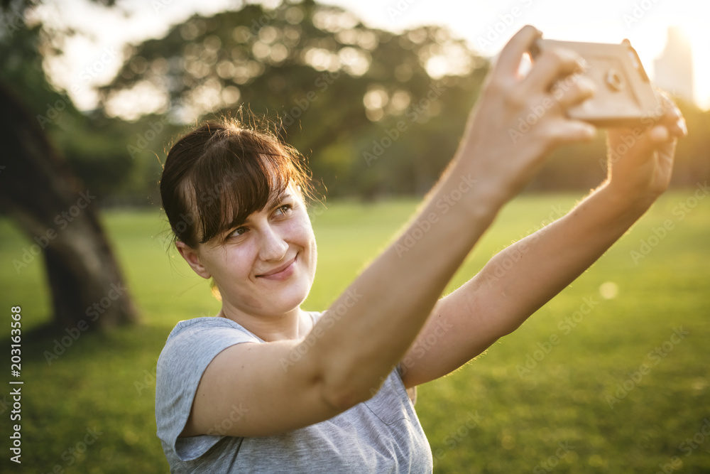 Woman taking a selfie at the park Woman taking a selfie at the park