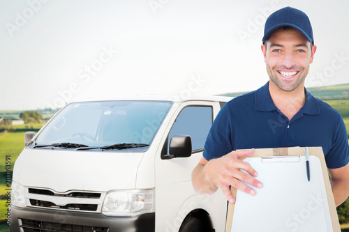 Happy delivery man with package and clipboard against scenic landscape © vectorfusionart