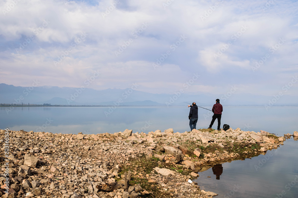 Lonesome fishermans traveler being reflected in Convento Viejo Dam, VI Region near Chimbarongo, Chile