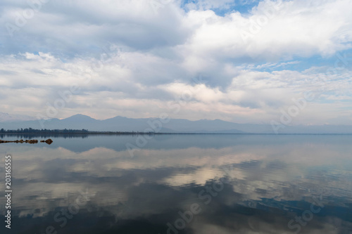 Symmetrical cloudy sky reflection in the water surface of Convento Viejo Dam in Chile, VI region near Chimbarongo and San Fernando