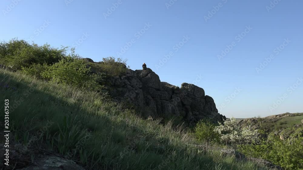mature man takes pictures of telephone edge view on mountainside, tourist backpack, , Canyon, high elephant cliffs, National Park mature man takes pictures of telephone edge view on mountainside, tourist backpack, , Canyon, high elephant cliffs, National Park