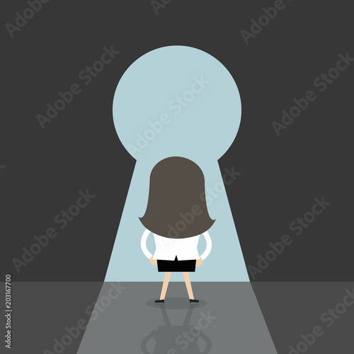 Businesswoman going to big keyhole.