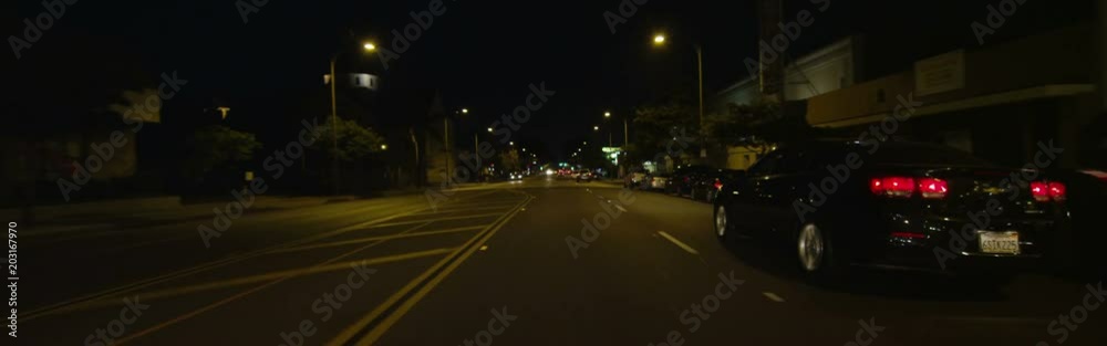 Front view of a Driving Plate: Car travels on East Colorado Boulevard in Pasadena, California at night, crossing Craig Avenue, pausing near Sierra Madre Boulevard, and continuing on to make a left turn at Sunnyslope Avenue.