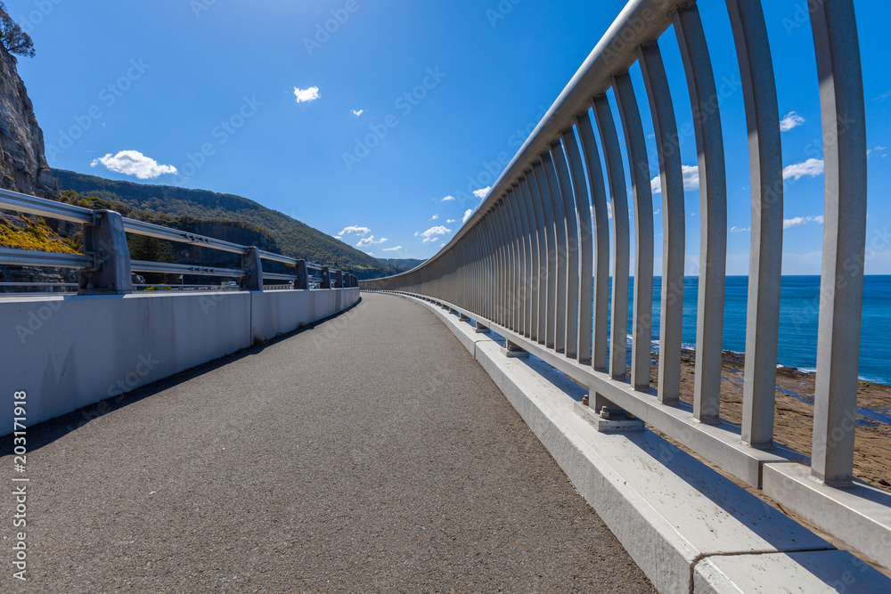 Walking path along the Sea Cliff Bridge on Grand Pacific Drive in Sydney, Australia