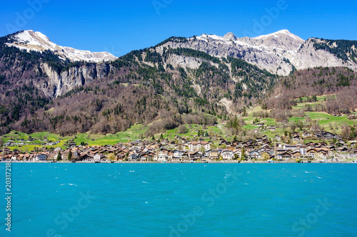Brienz town on Lake Brienz by Interlaken, Switzerland, with snow covered Alps mountains in background © navintar