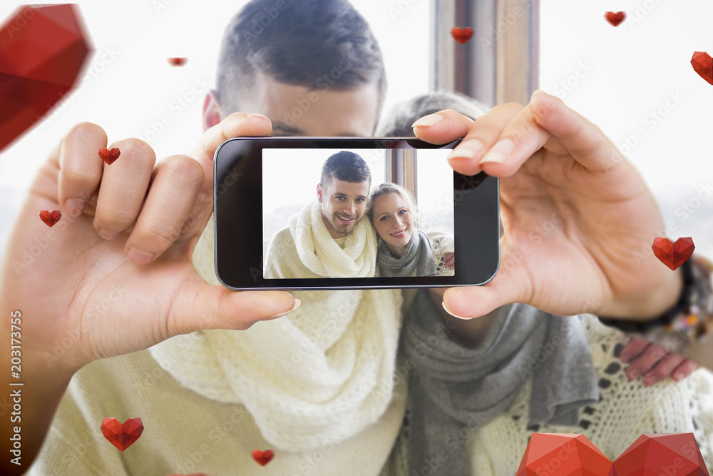 Composite image of valentines couple taking a selfie