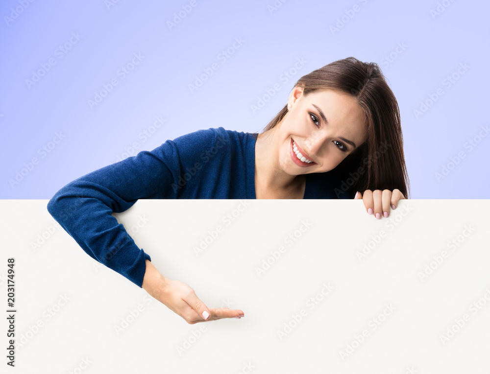 Woman in casual clothing showing blank signboard Woman in casual clothing showing blank signboard