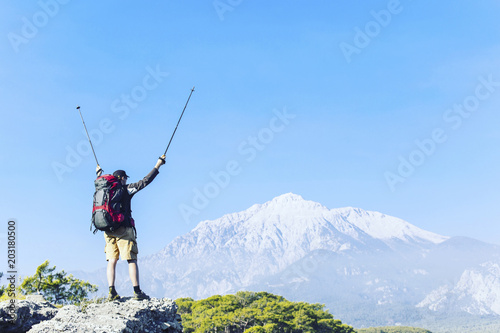 Summer hike in the mountains with a backpack and tent.