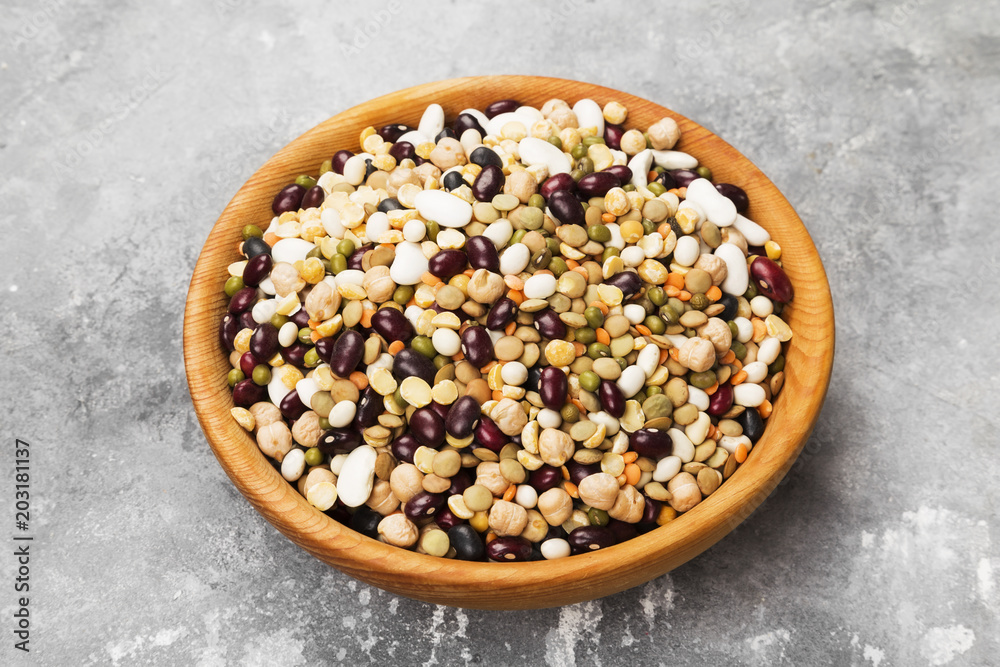 Assortment of beans (red lentil, green lentil, chickpea, peas, red beans, white beans, mix beans, mung bean) on gray background Assortment of beans (red lentil, green lentil, chickpea, peas, red beans, white beans, mix beans, mung bean) on gray background