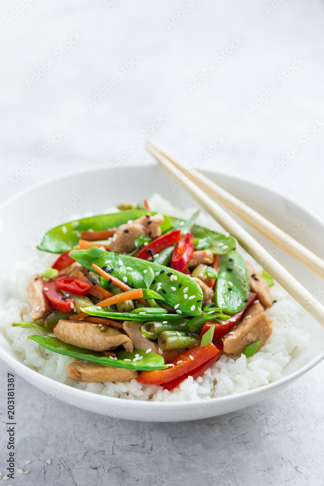 stir fry chicken and vegetables with rice in white bowl stir fry chicken and vegetables with rice in white bowl