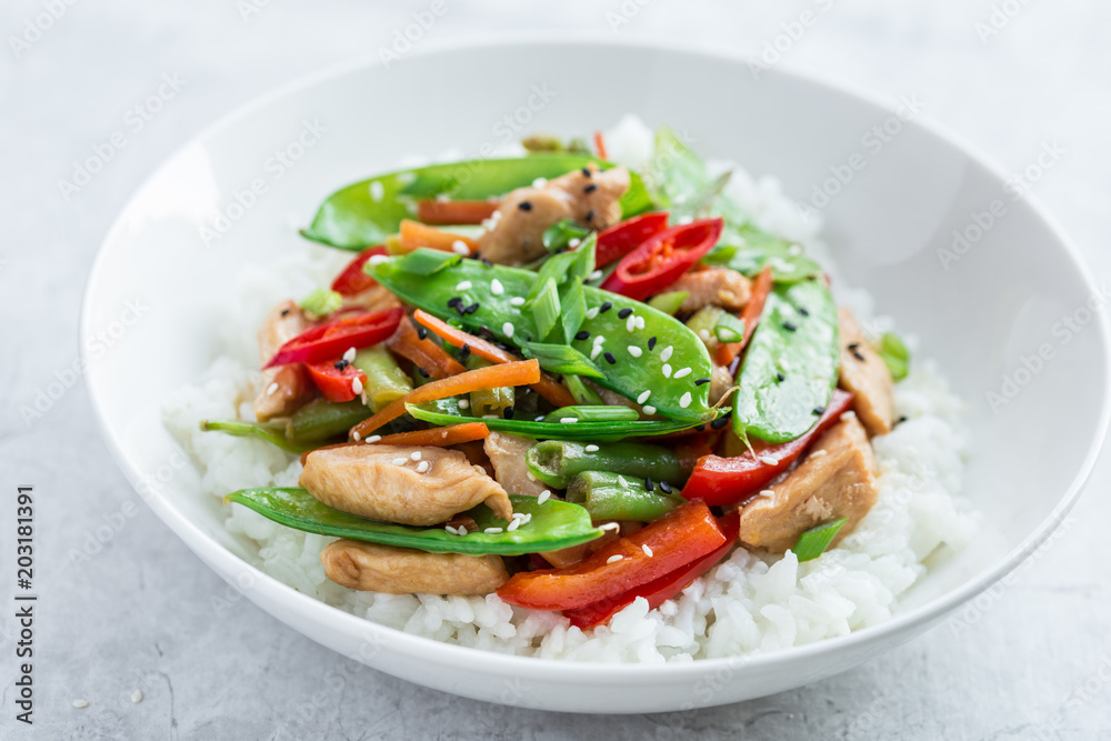 stir fry chicken and vegetables with rice in white bowl stir fry chicken and vegetables with rice in white bowl