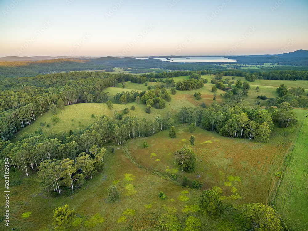 Obraz premium Aerial view of rural area and Myall Lake at sunset. Topi Topi, New South Wales, Australia