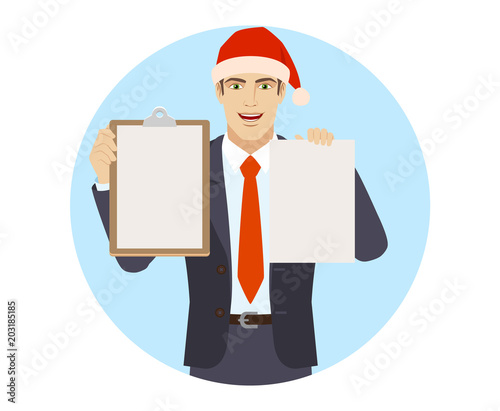 Businessman in Santa hat holding the clipboard and paper