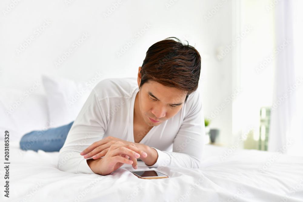 Men are playing mobile in the bedroom.