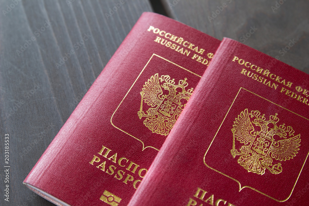 Russian passports isolated on wood background. Closeup Russian passports isolated on wood background. Closeup