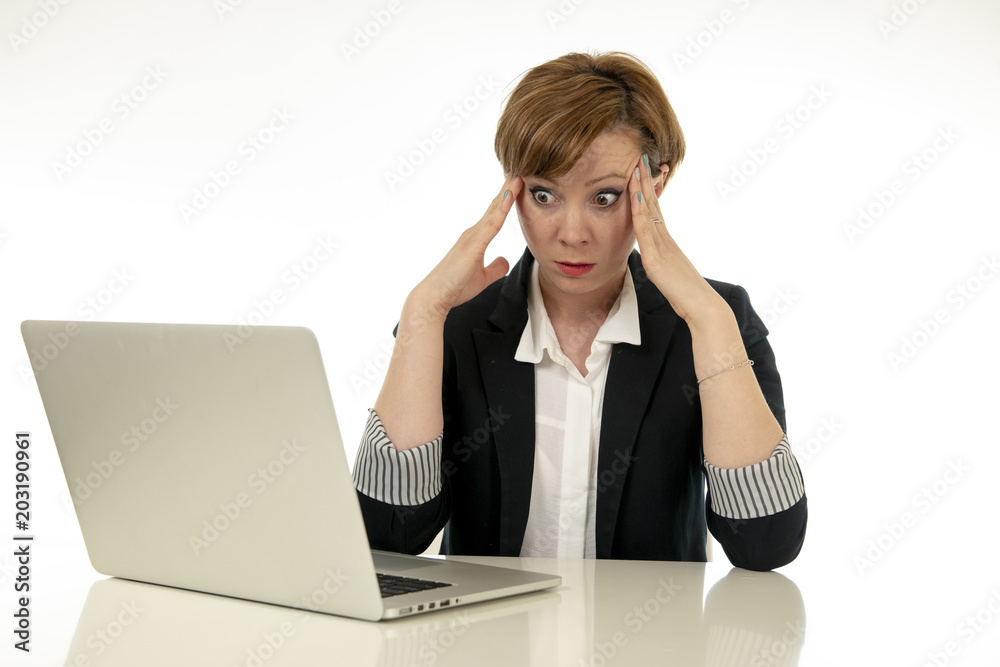 Attractive young business woman working on her computer stressed, tired and overwhelmed. Attractive young business woman working on her computer stressed, tired and overwhelmed.