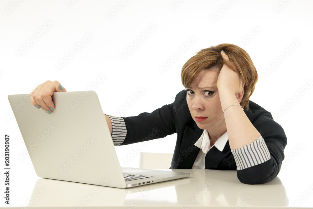 Attractive young business woman working on her computer stressed, tired and overwhelmed. Attractive young business woman working on her computer stressed, tired and overwhelmed.
