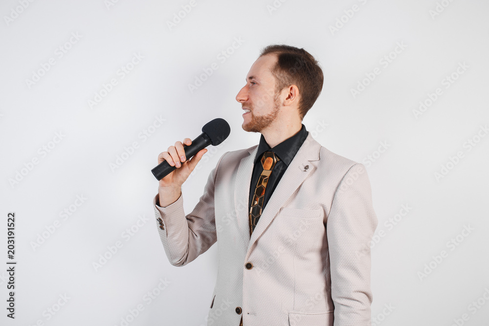 Young man with microphone on white background, leading with microphone Young man with microphone on white background, leading with microphone