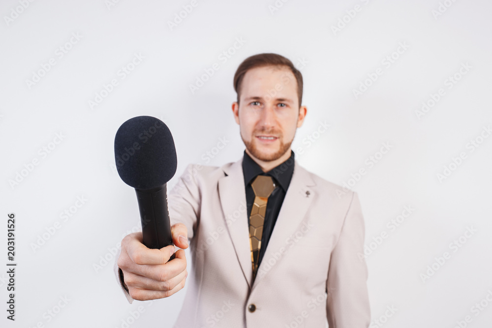 Young man with microphone on white background, leading with microphone Young man with microphone on white background, leading with microphone