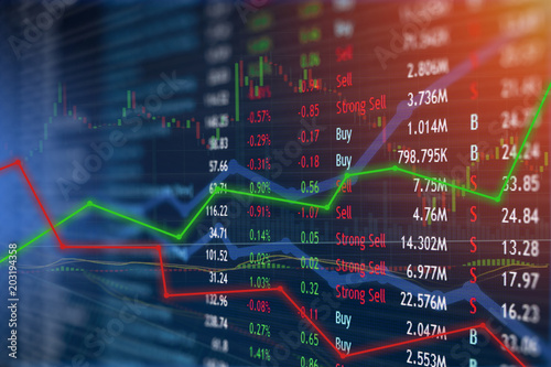 Investing and stock market concept gain and profits with faded candlestick charts.