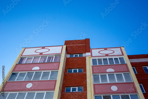 Facade of an apartment building against the blue sky