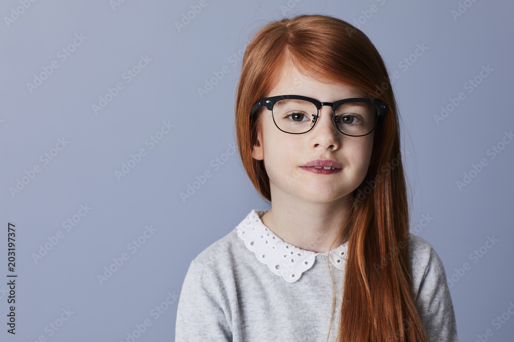Glasses girl with red hair looking to camera Glasses girl with red hair looking to camera
