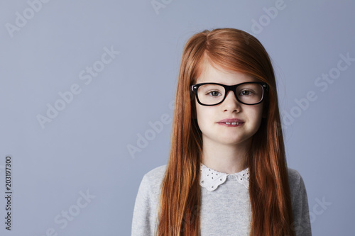 Obraz na płótnie Red headed girl in glasses, portrait