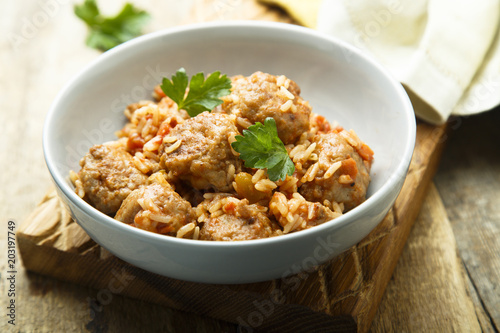 Homemade meatballs with rice, tomato and fresh parsley