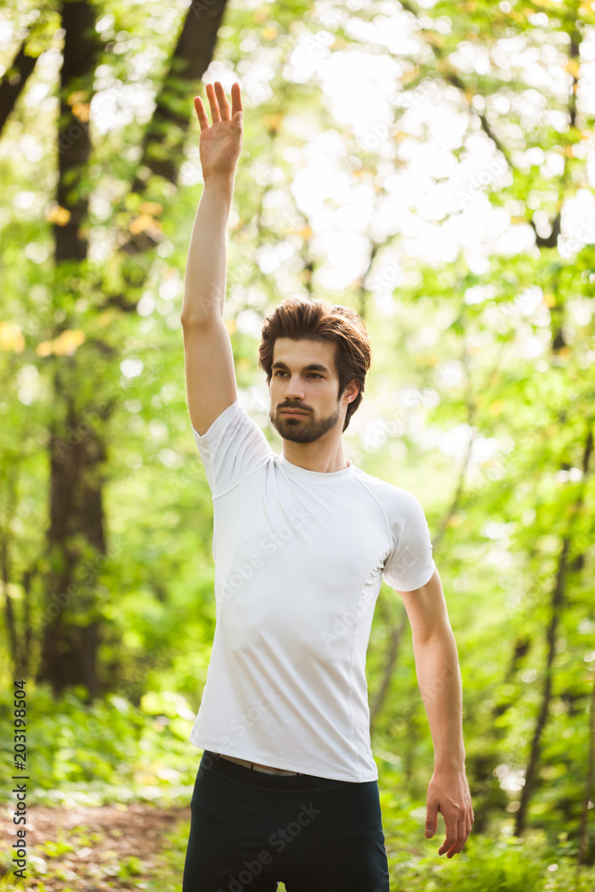 Young man is exercising. He is stretching his body. Young man is exercising. He is stretching his body.