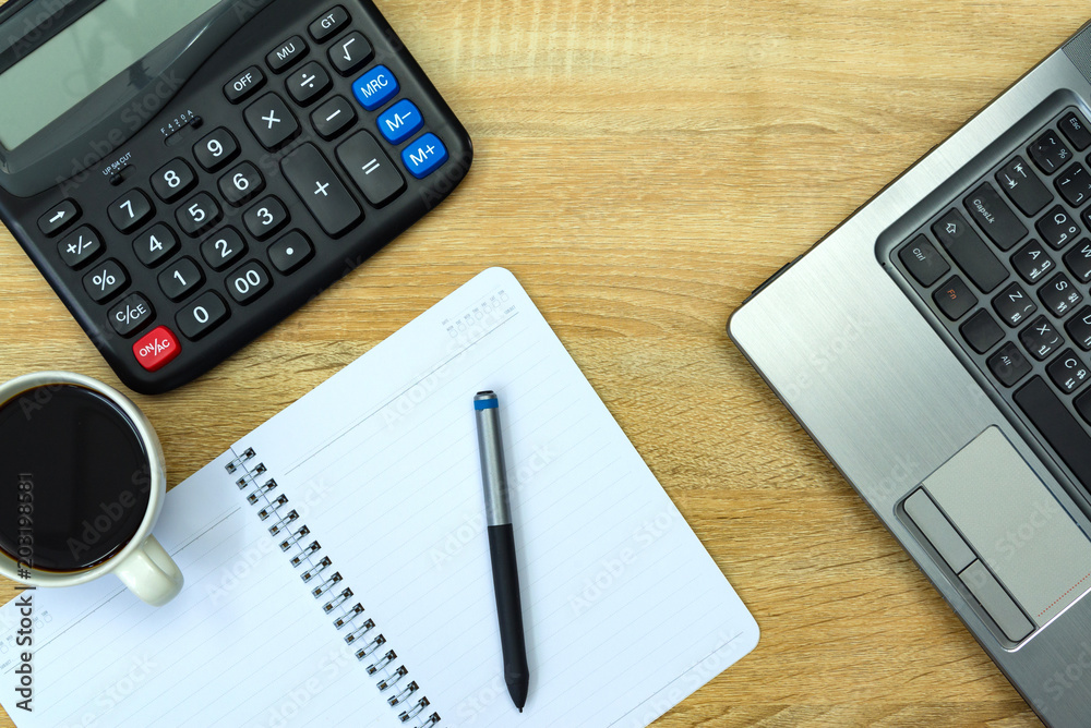 Laptop computer or notebook, calculator and cup of coffee on working table with copy space top view. Laptop computer or notebook, calculator and cup of coffee on working table with copy space top view.