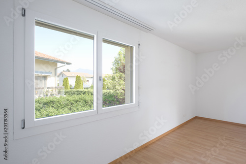 Empty room with parquet and window