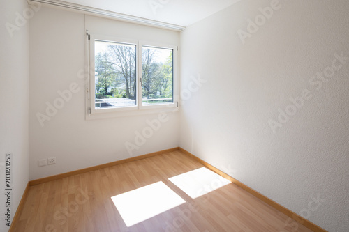 Empty room with parquet and window