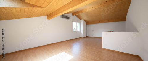 Large attic with wooden floors and exposed beams