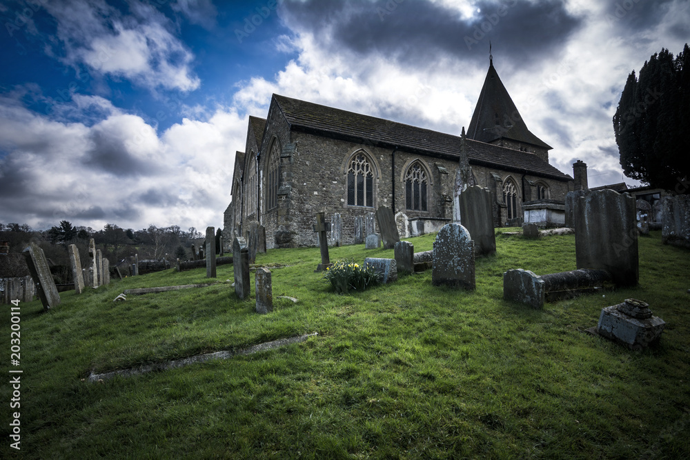 English church and graveyard in dramatic light
