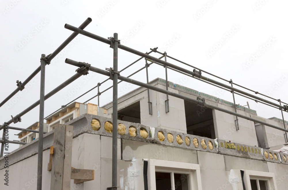Building site with house under construction Building site with house under construction