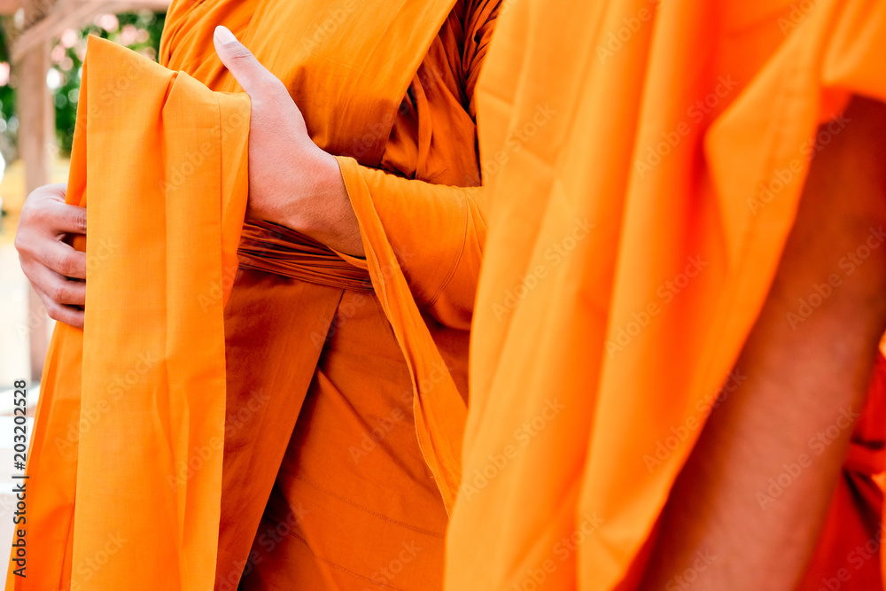 Yellow robe of Buddhist monks, Closeup on buddhist monk Yellow robe of Buddhist monks, Closeup on buddhist monk