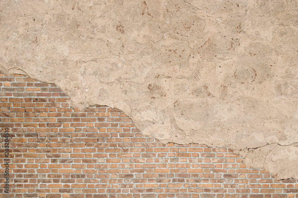 Fototapeta premium Vintage textured old brick wall with stained and shabby uneven plaster background. Copy space for text.