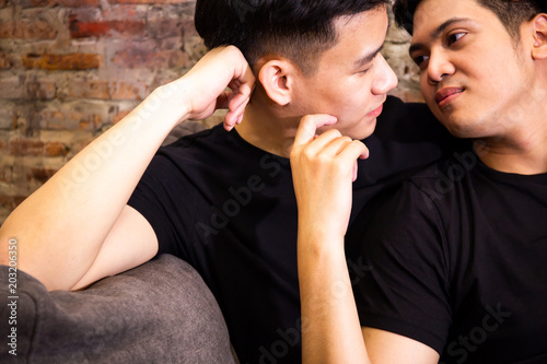Asian gay couple looking at each other together at vintage home. Portrait of happy gay men - Homosexual love concept
