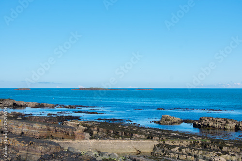 volcanic rock formation on coast of ocean in northern Ireland horizon over water 