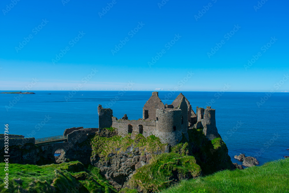 beautiful landscape Dunluce Castle against blue sea and sky. one of most popular place in northern ireland 