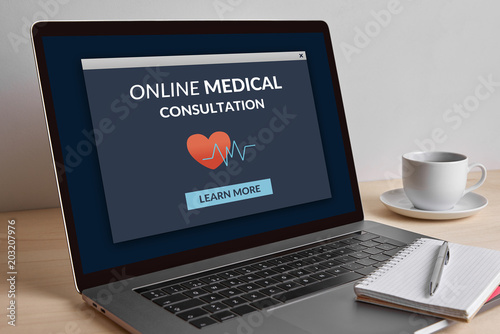 Online medical consultation concept on modern laptop computer screen on wooden table. All screen content is designed by me.