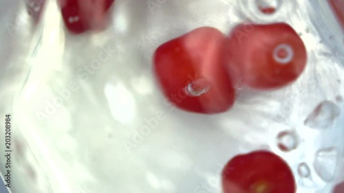 Motion of sweet cherries dropping into water photo