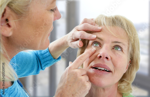 Senior medical check up with focus on eyes examinationat doctor's office