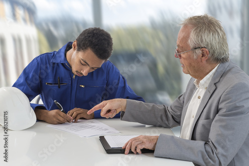 apprentice contract signature over an open space interior with large windows background