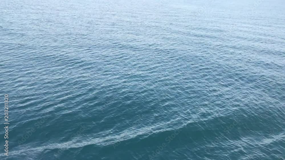 Sea water waves on side of boat while moving, Boat cutting water surface during cruise. Water splashing on blue ocean. Sea water waves on side of boat while moving, Boat cutting water surface during cruise. Water splashing on blue ocean.