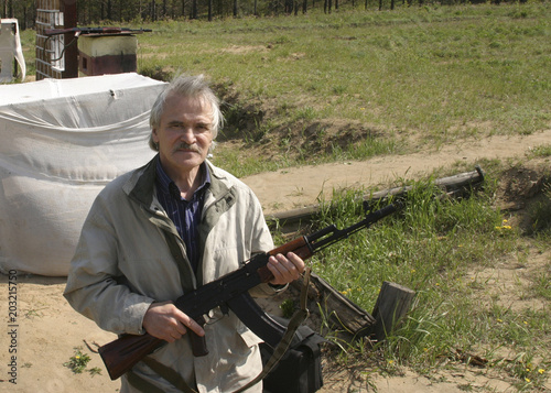Obraz na plátně A man with a Kalashnikov rifle